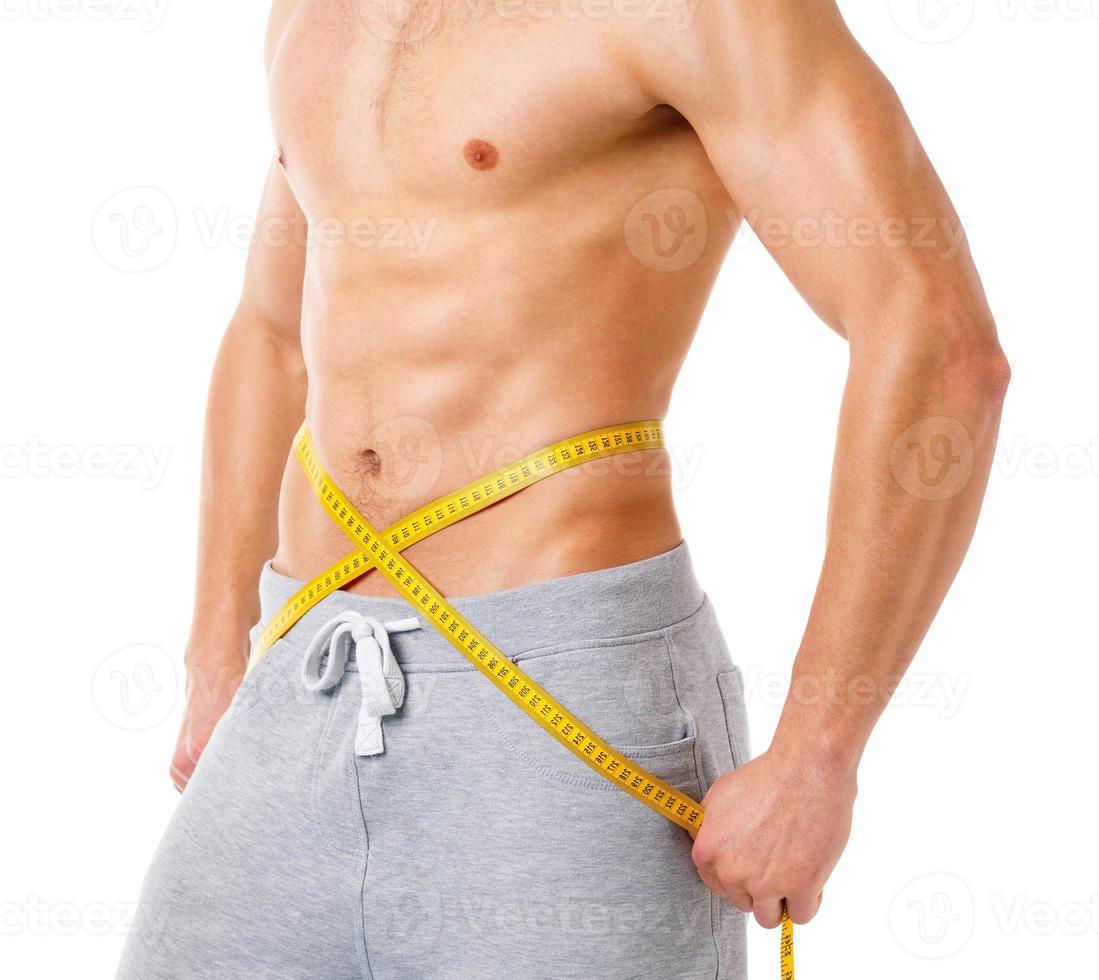 Athletic man with measuring tape on the white photo