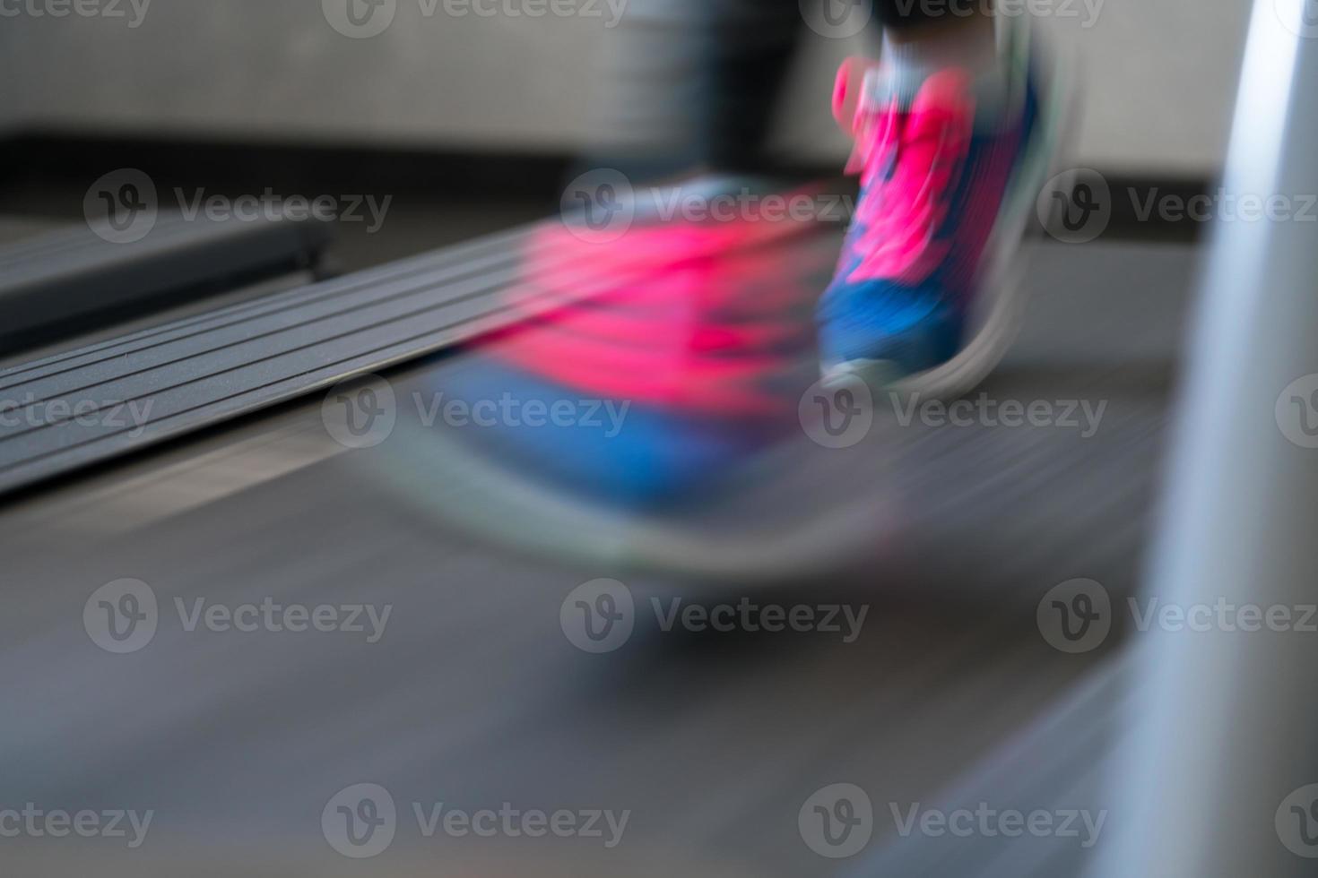 Woman running on treadmill photo