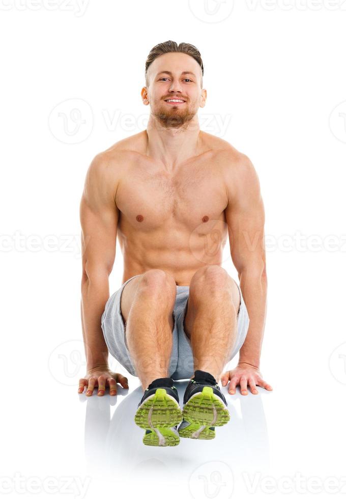 Sport attractive man doing fitness exercises on the white photo