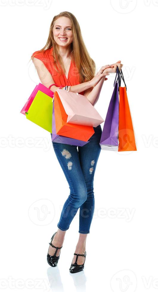 Happy lovely woman with shopping bags over white photo