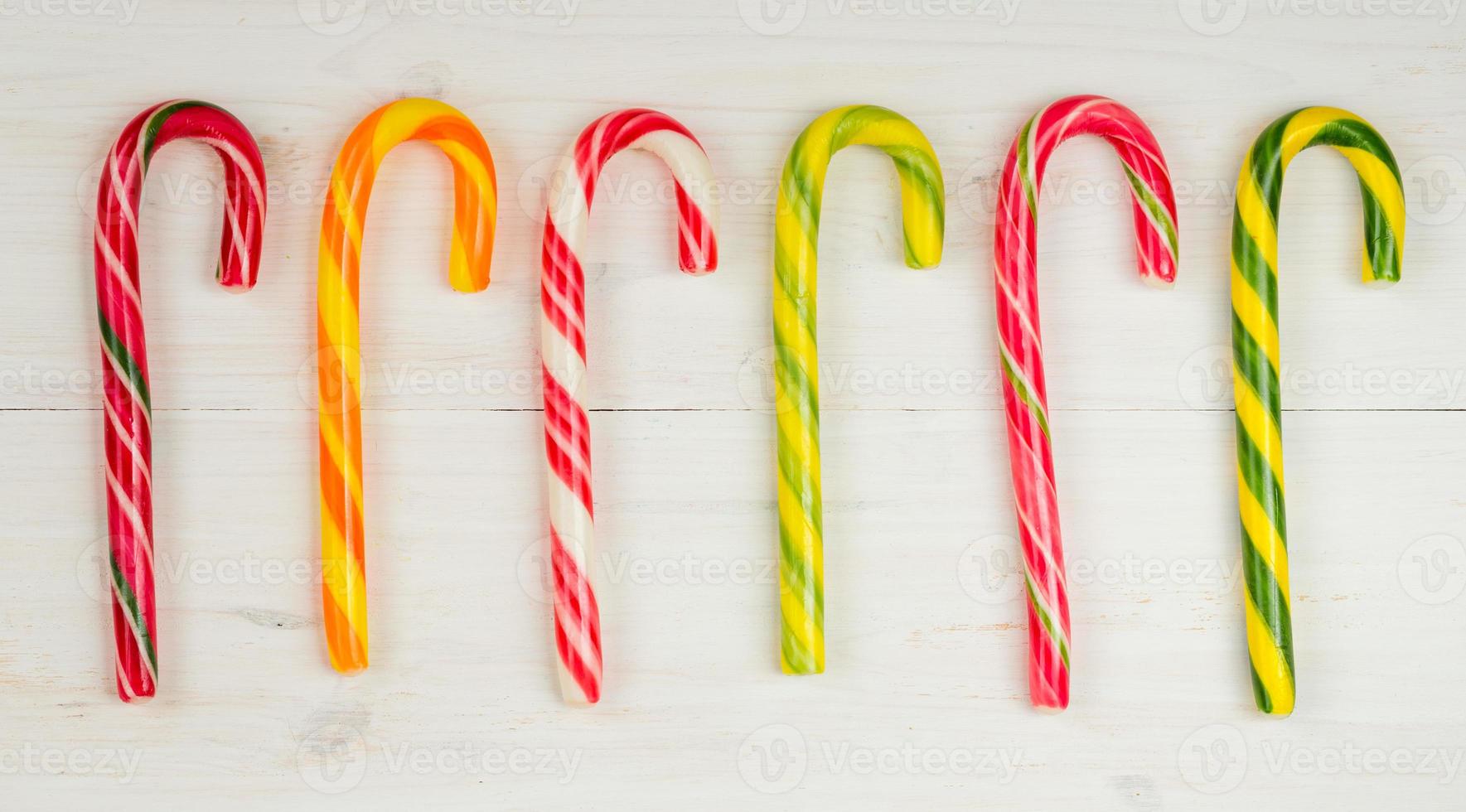 Christmas candy cane on a wooden background photo