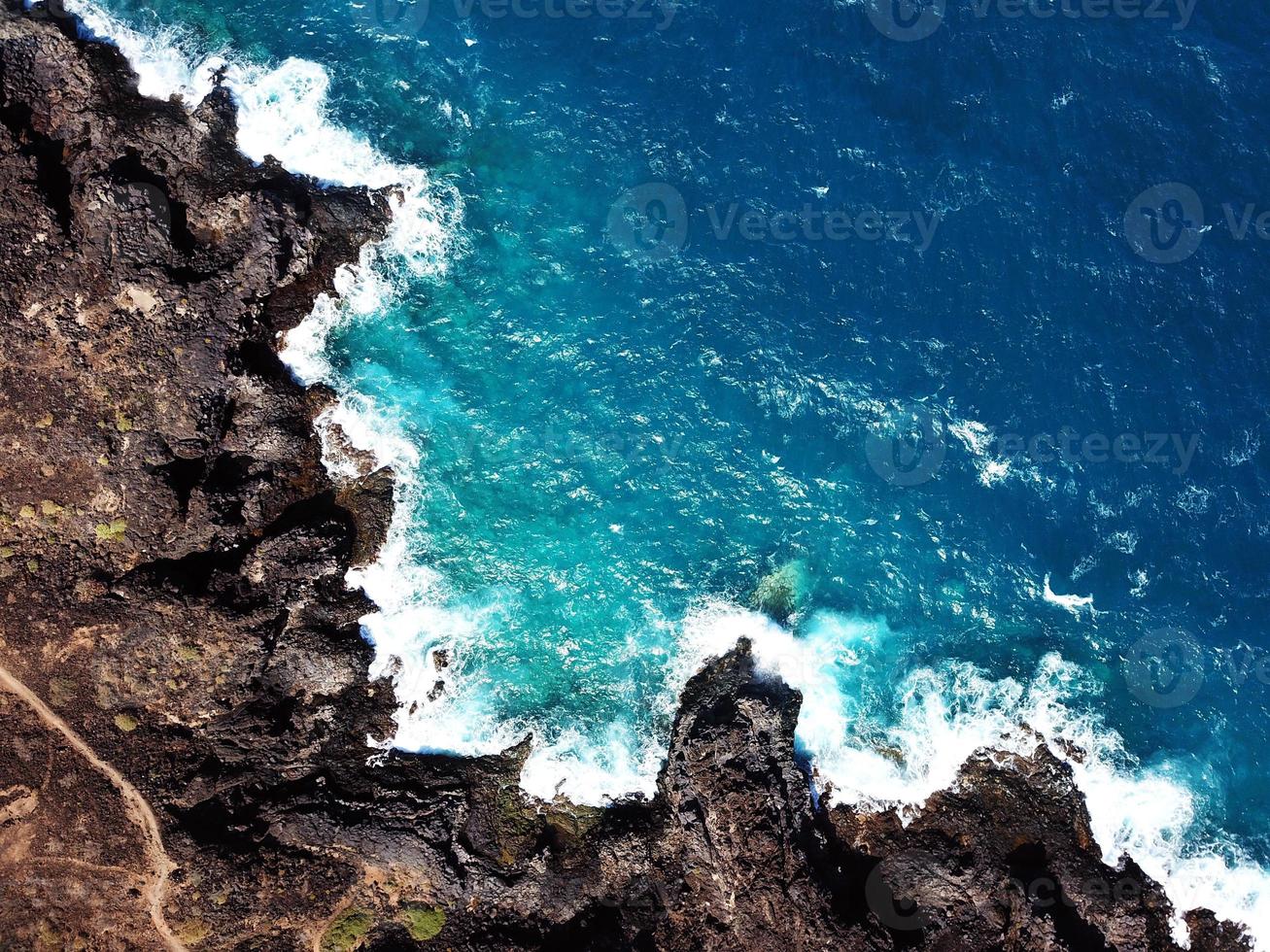 Top view of a deserted coast. Rocky shore of the island of Tenerife. Aerial drone footage of sea waves reaching shore photo