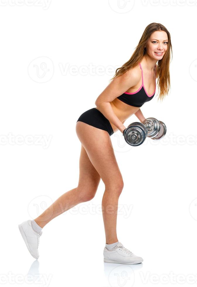 Happy athletic woman with dumbbells doing sport exercise, isolated on white photo