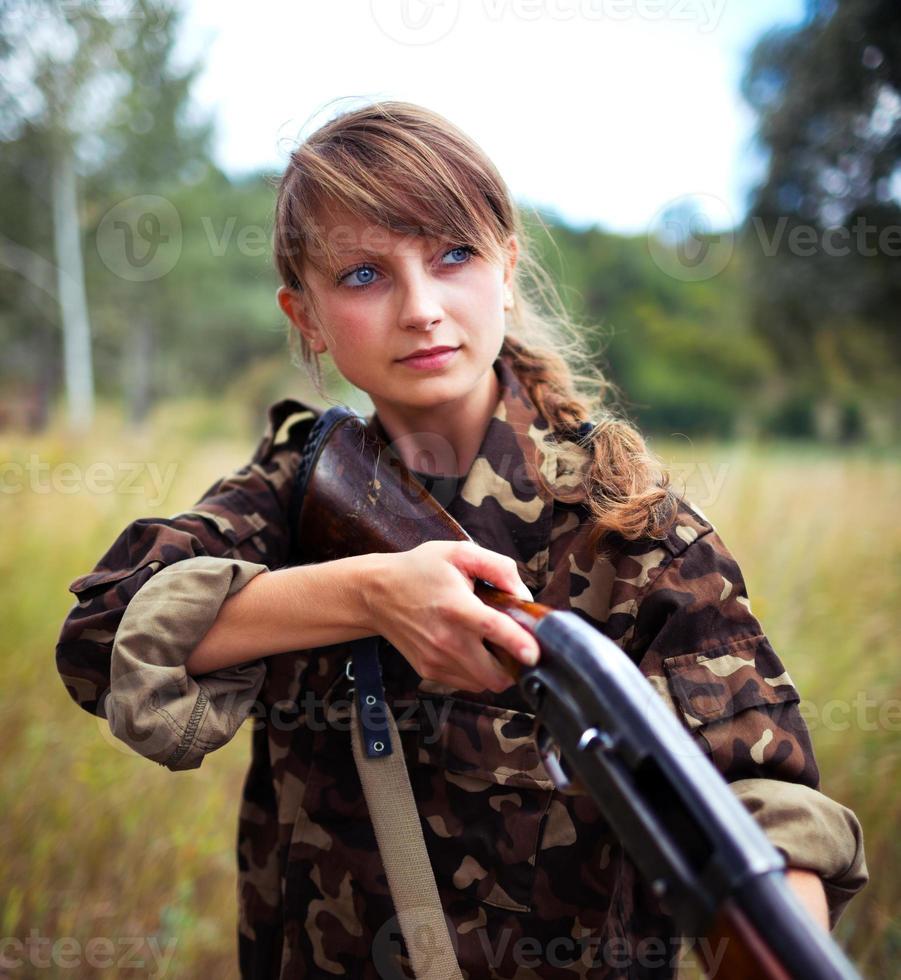 Young beautiful girl with a shotgun photo