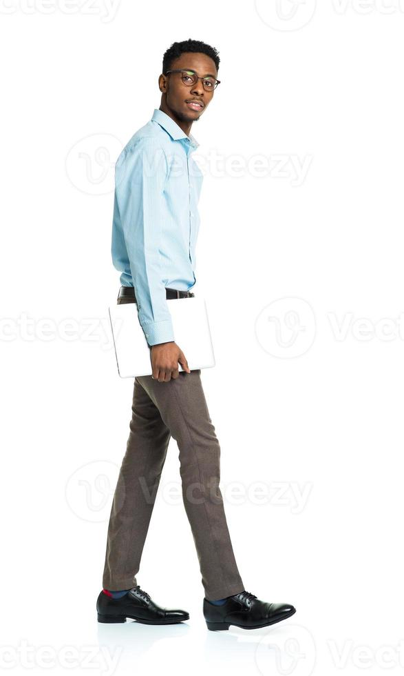 African american college student with laptop standing on white photo