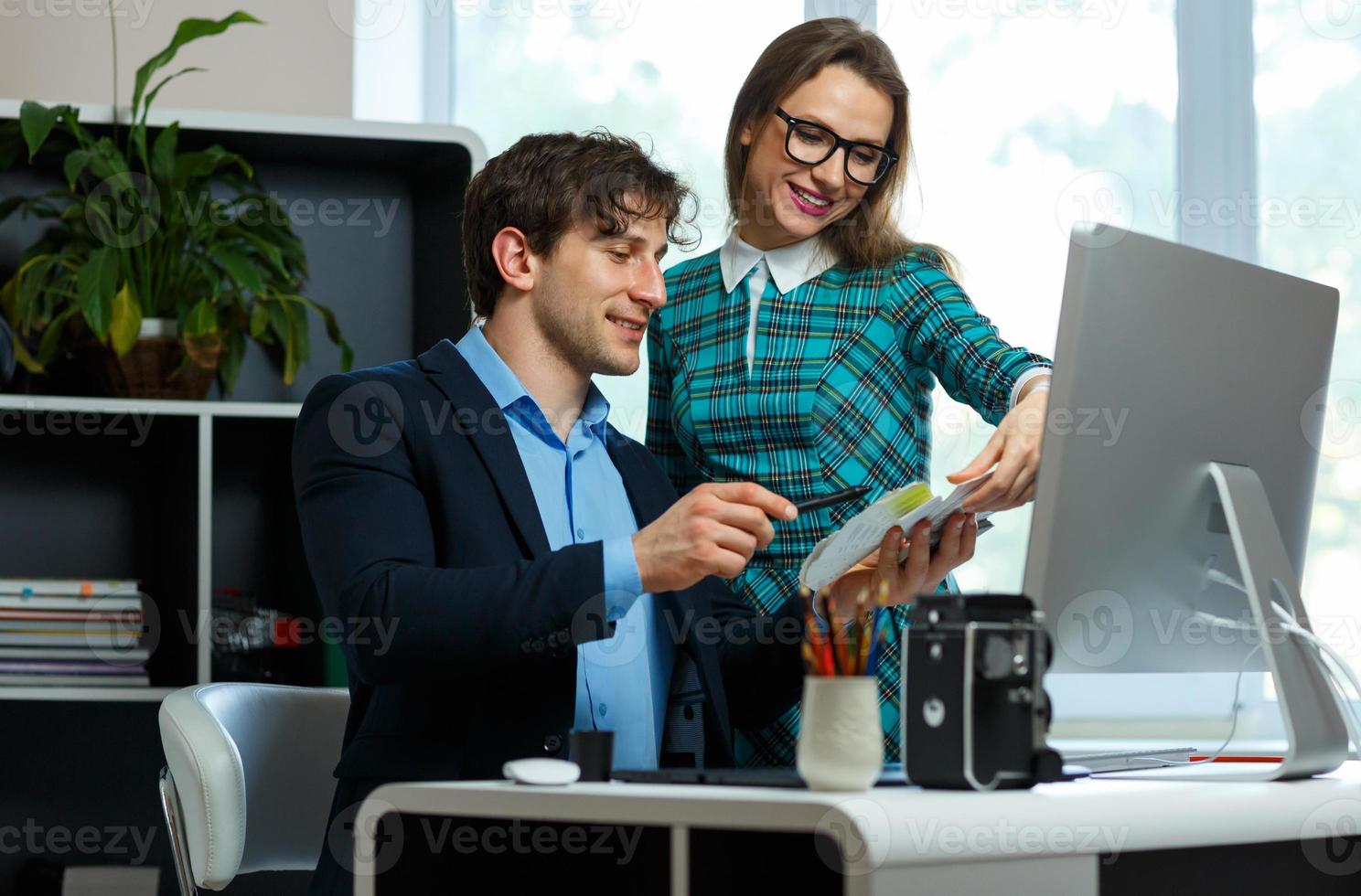 Young colleague - man and woman working from home - modern business concept photo