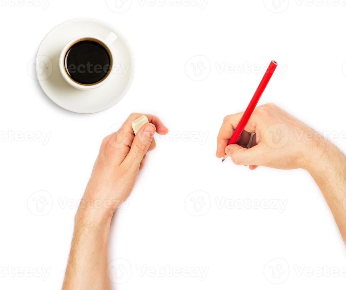 Human hands with pencil and erase rubber and cup of coffee photo