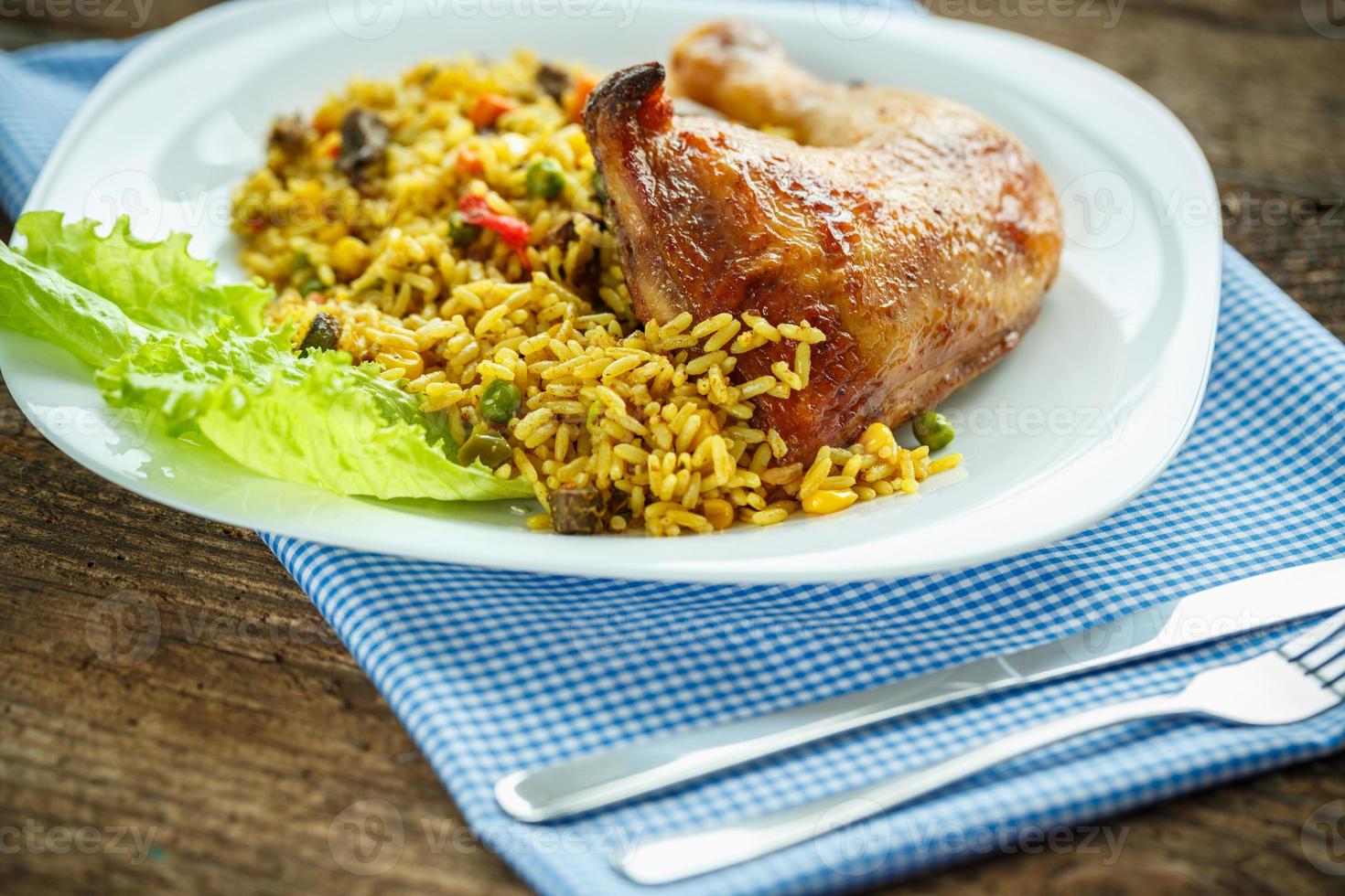 Delicious dishes from chicken thigh with rice and salad leaves photo