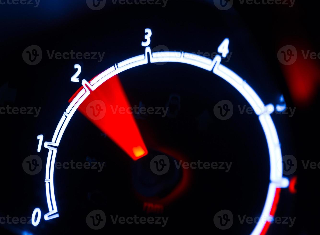 Tachometer illuminated at night photo