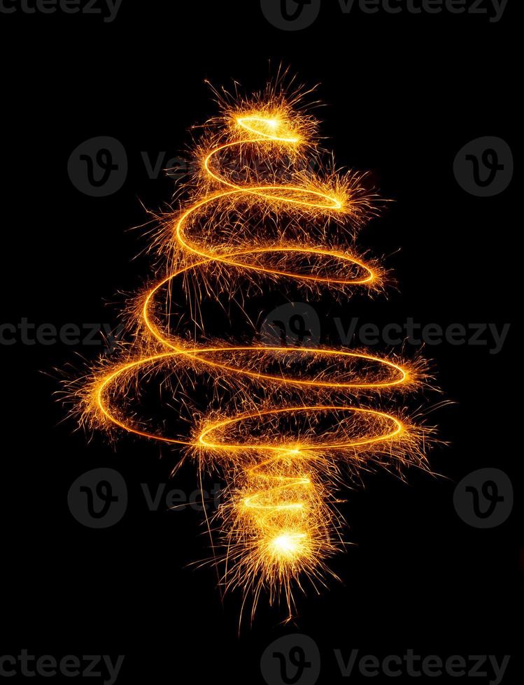 Christmas tree made by sparkler on a black photo