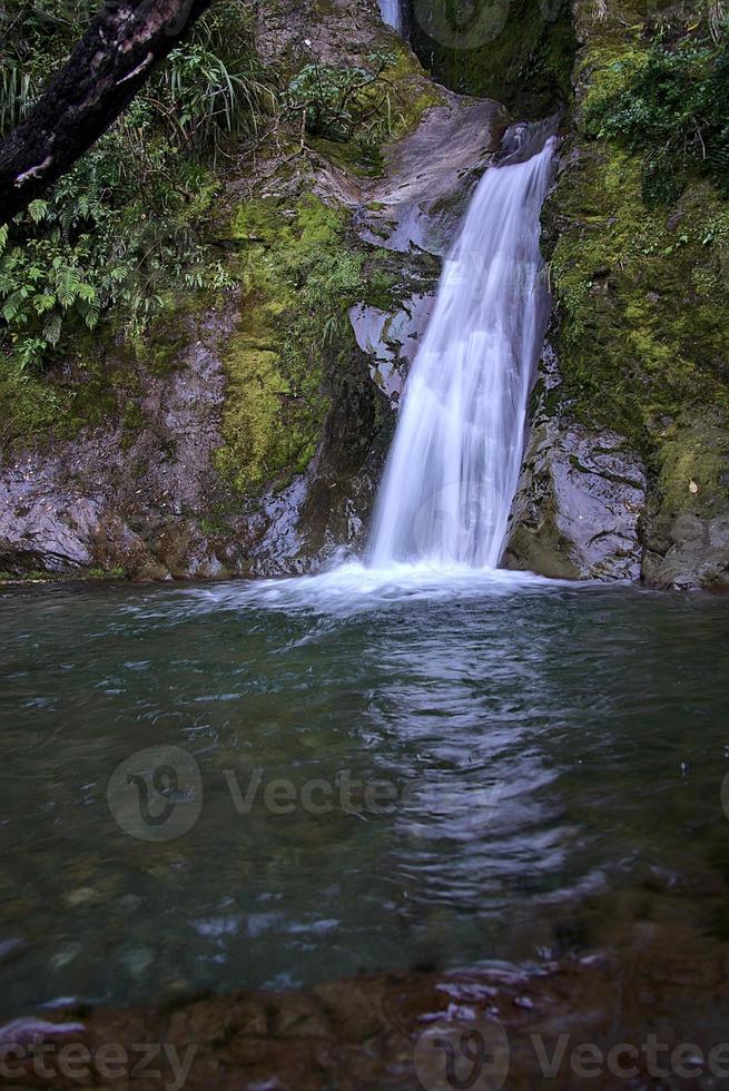 waterfall hiden in the forest photo