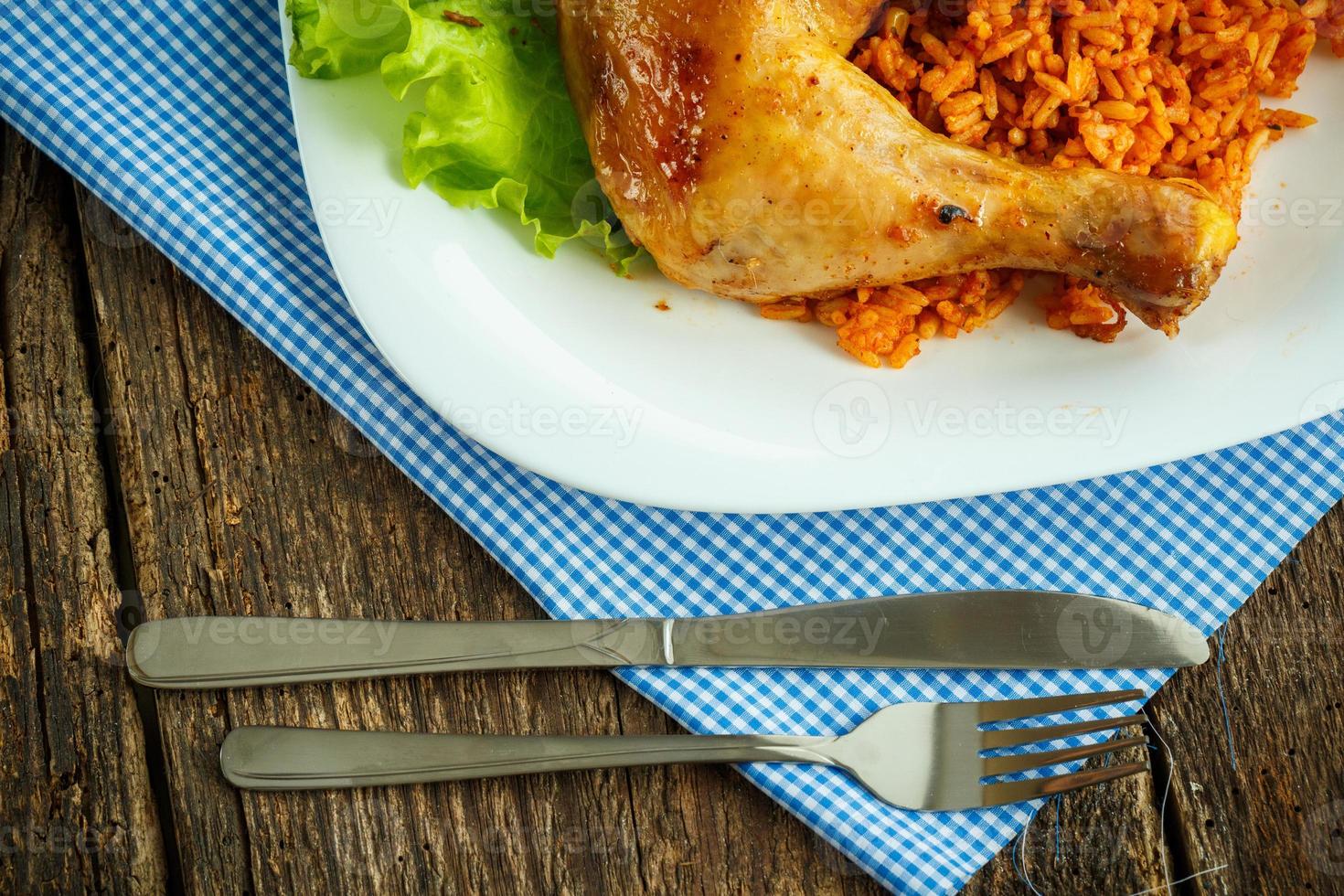 Delicious dishes from chicken thigh with rice and salad leaves photo