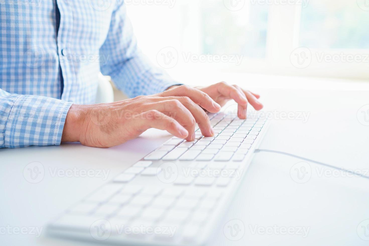 Men office worker typing on the keyboard photo