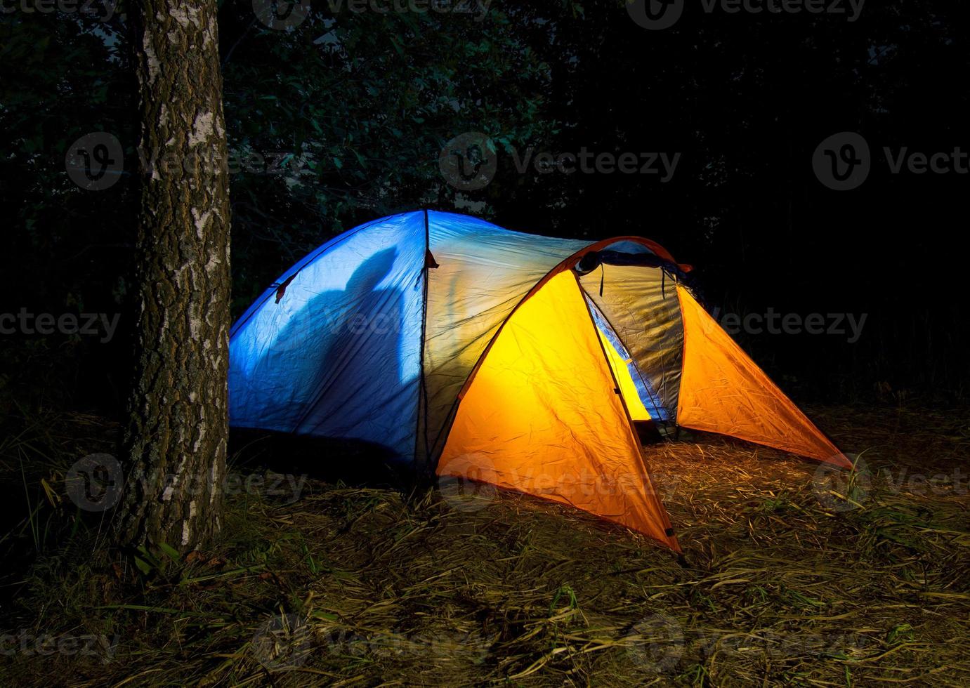 Tent illuminated from the inside photo