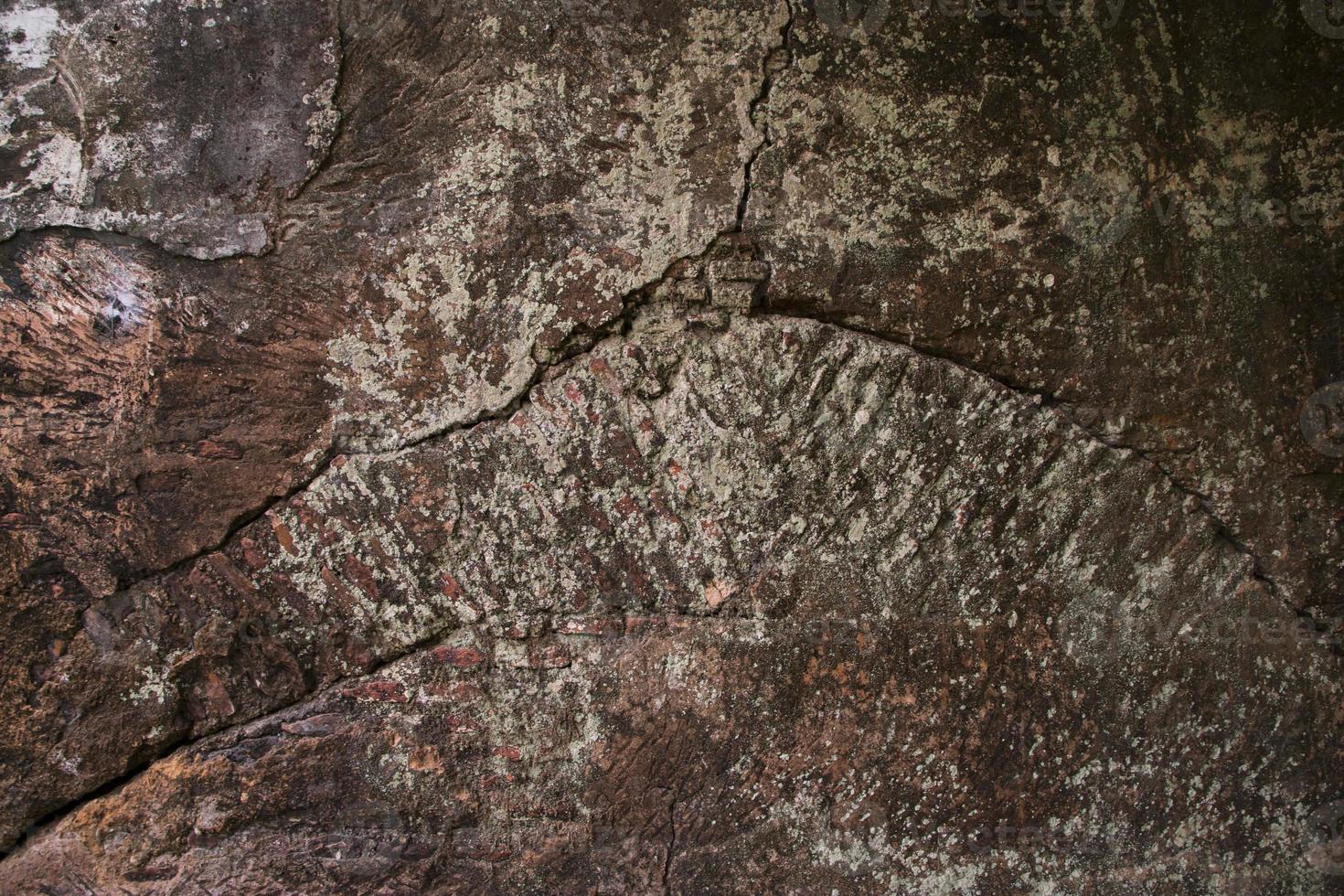 Stone texture background. Close-up of a stone surface with cracks and scratches photo