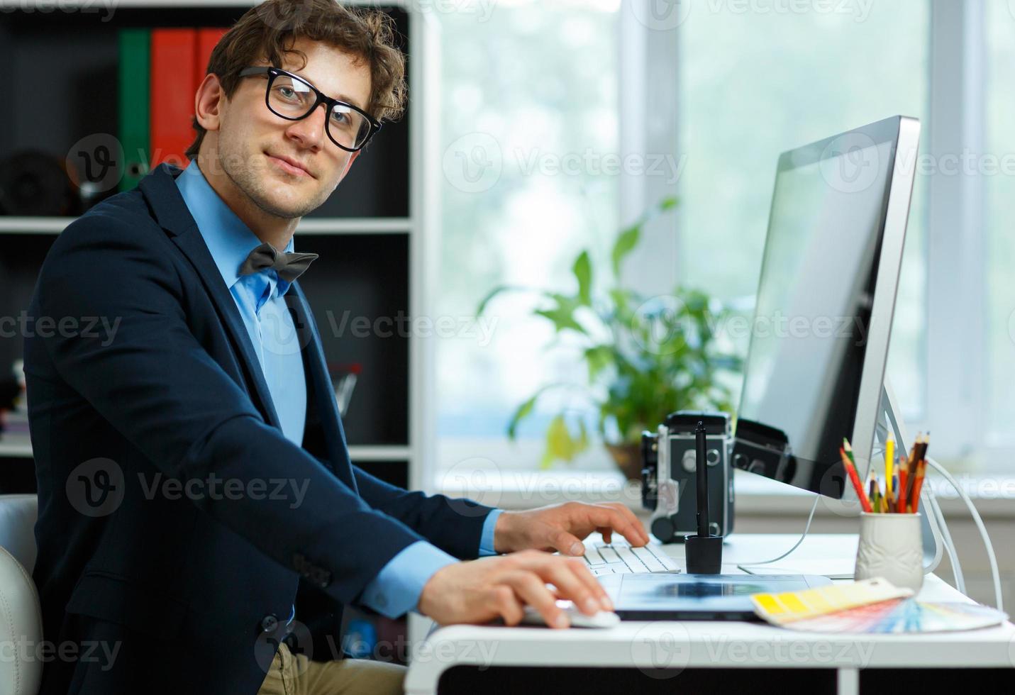 Handsome young man working from home office photo