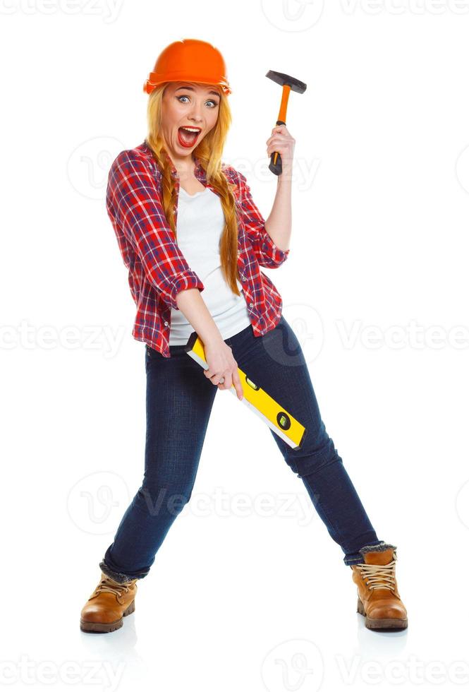 Young woman worker in helmet with the work tools on a white photo