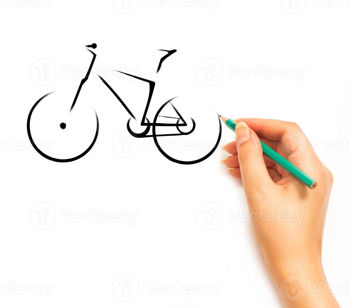 Woman's Hand draws a bicycle on white photo