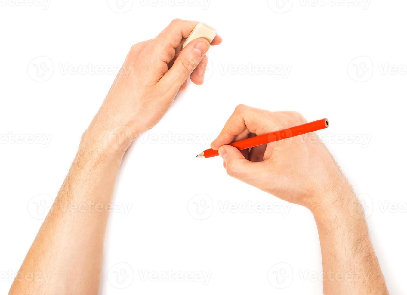 Human hands with pencil and erase rubber writting something photo