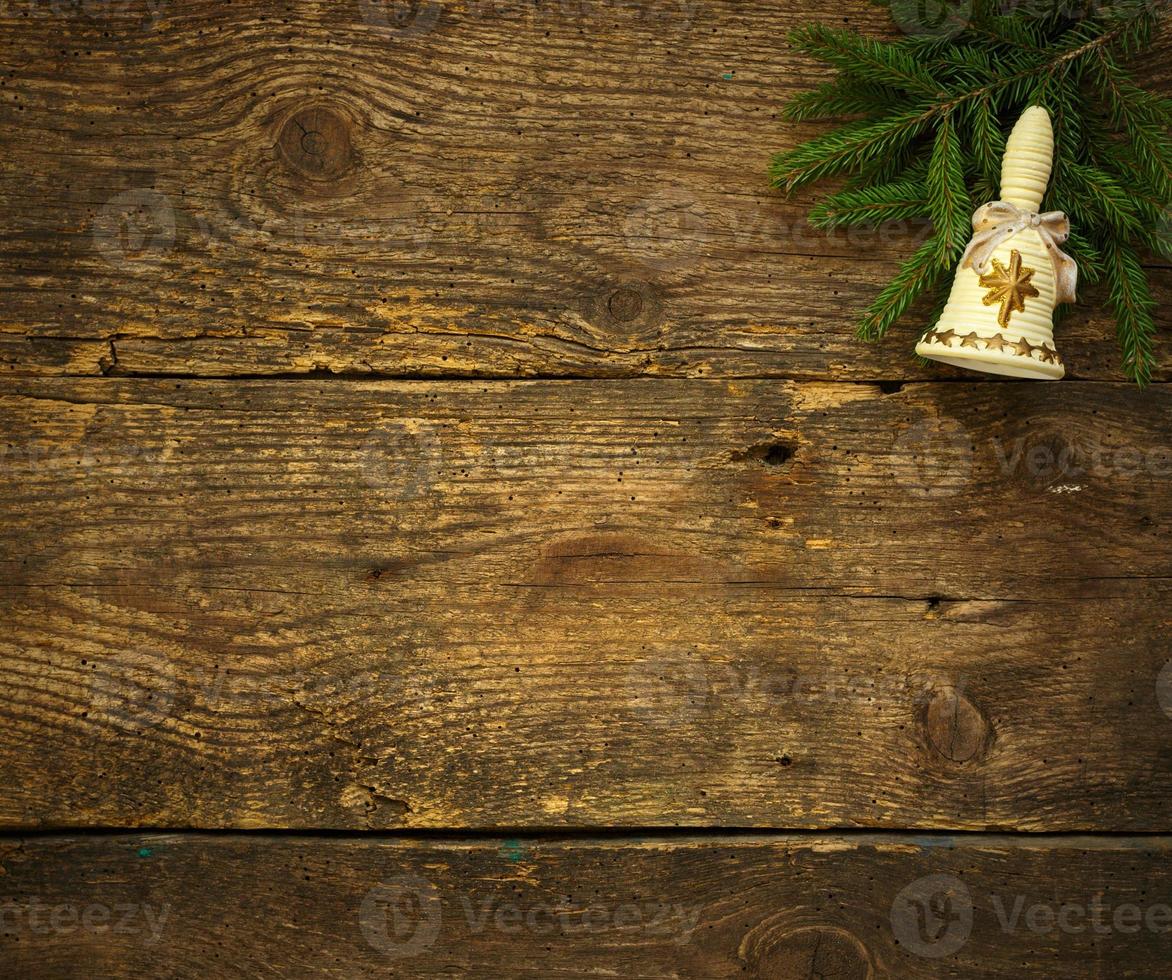 Christmas tree branches with christmas decorations on wooden texture ready for your design photo