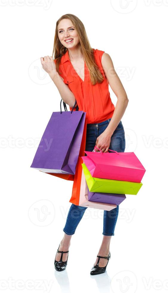 Happy lovely woman with shopping bags over white photo