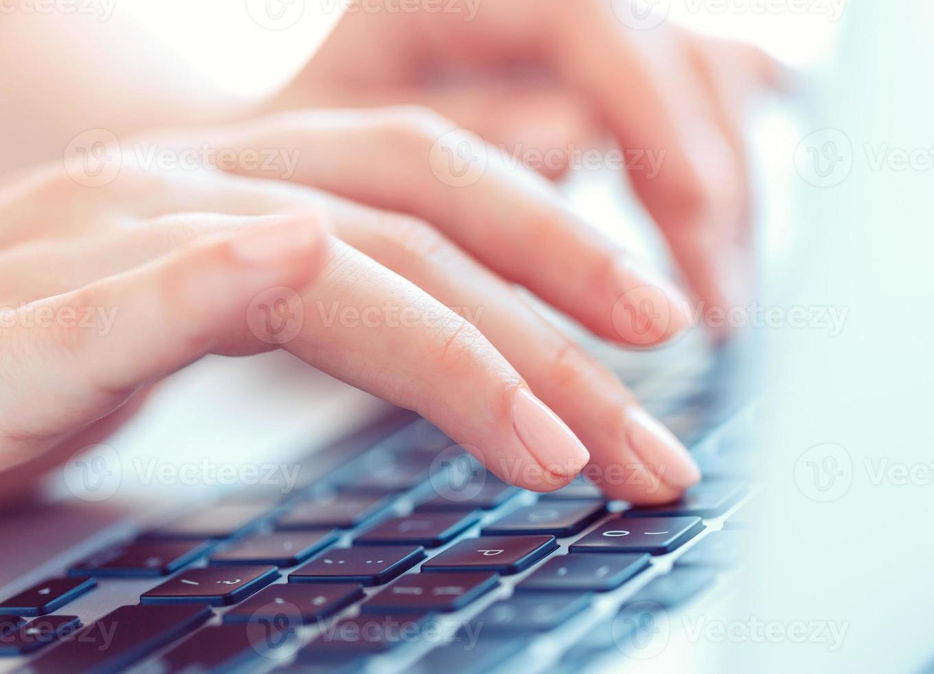 Female hands or woman office worker typing on the keyboard photo