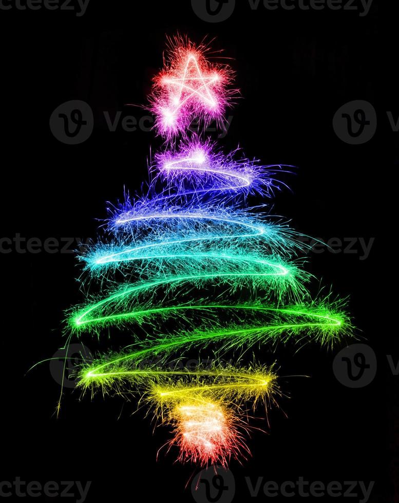 Christmas tree made by sparkler on a black photo