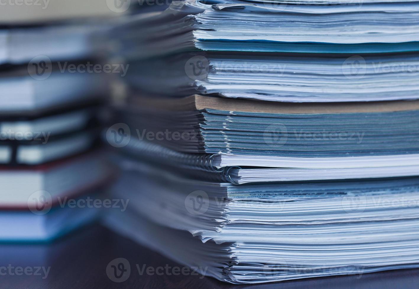 Accounting and taxes. Large pile of magazine and books photo