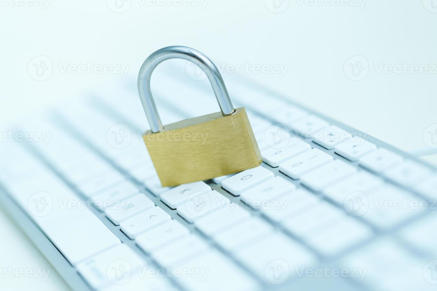 Security lock on white computer keyboard photo