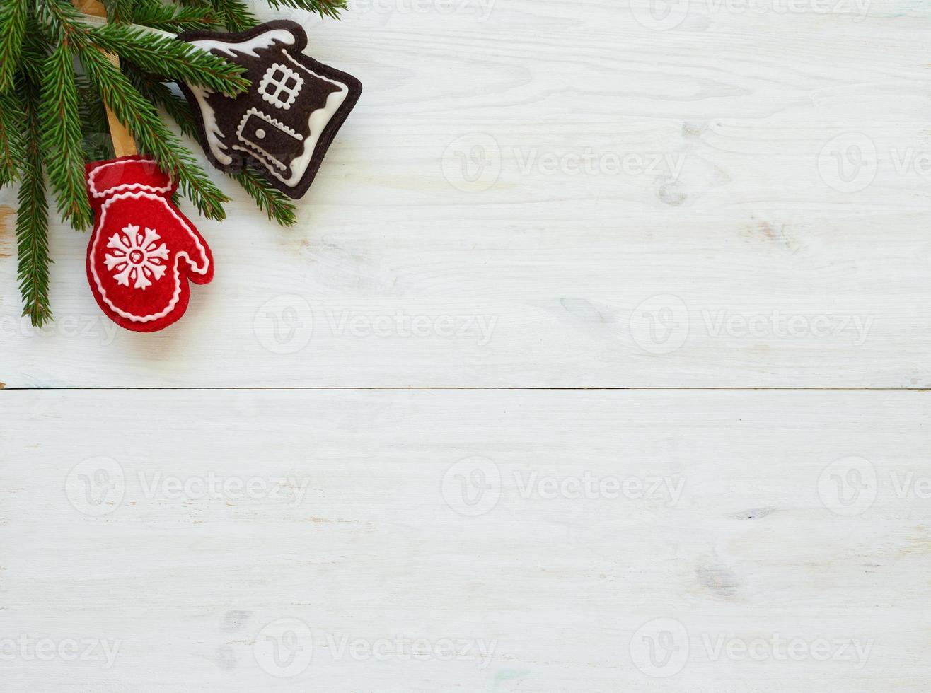 Christmas tree branches with cones, christmas decorations on white wooden texture ready for your design photo