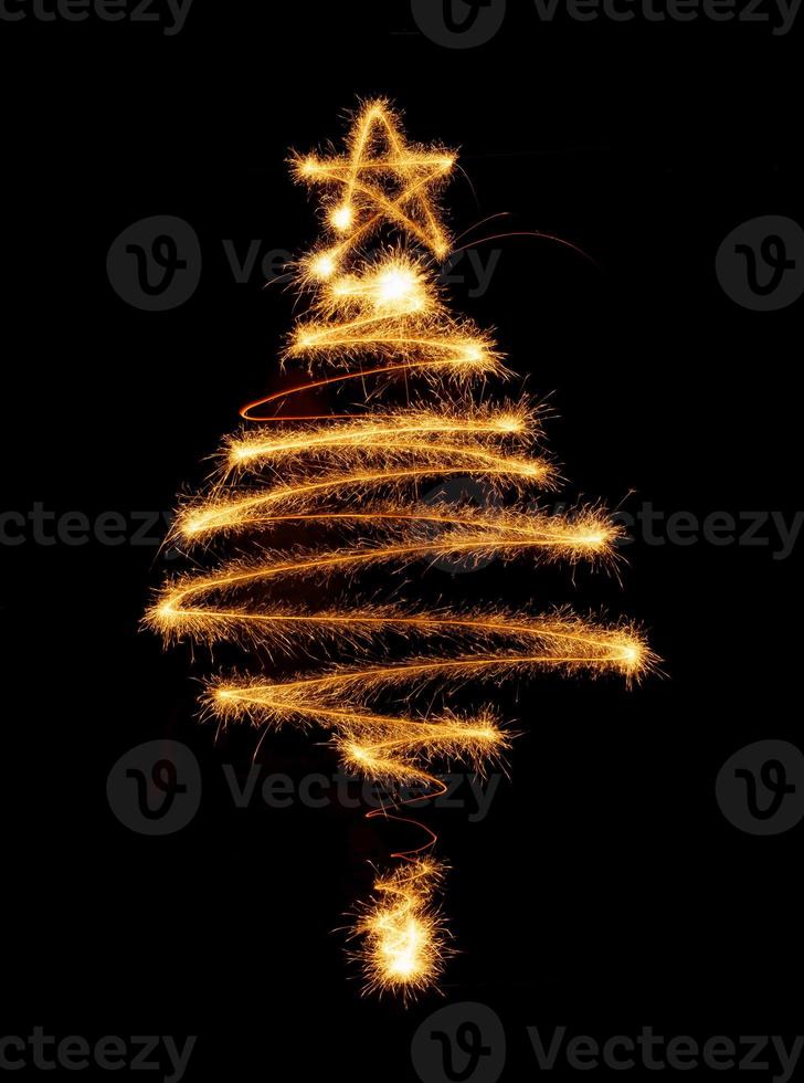 Christmas tree made by sparkler on a black photo