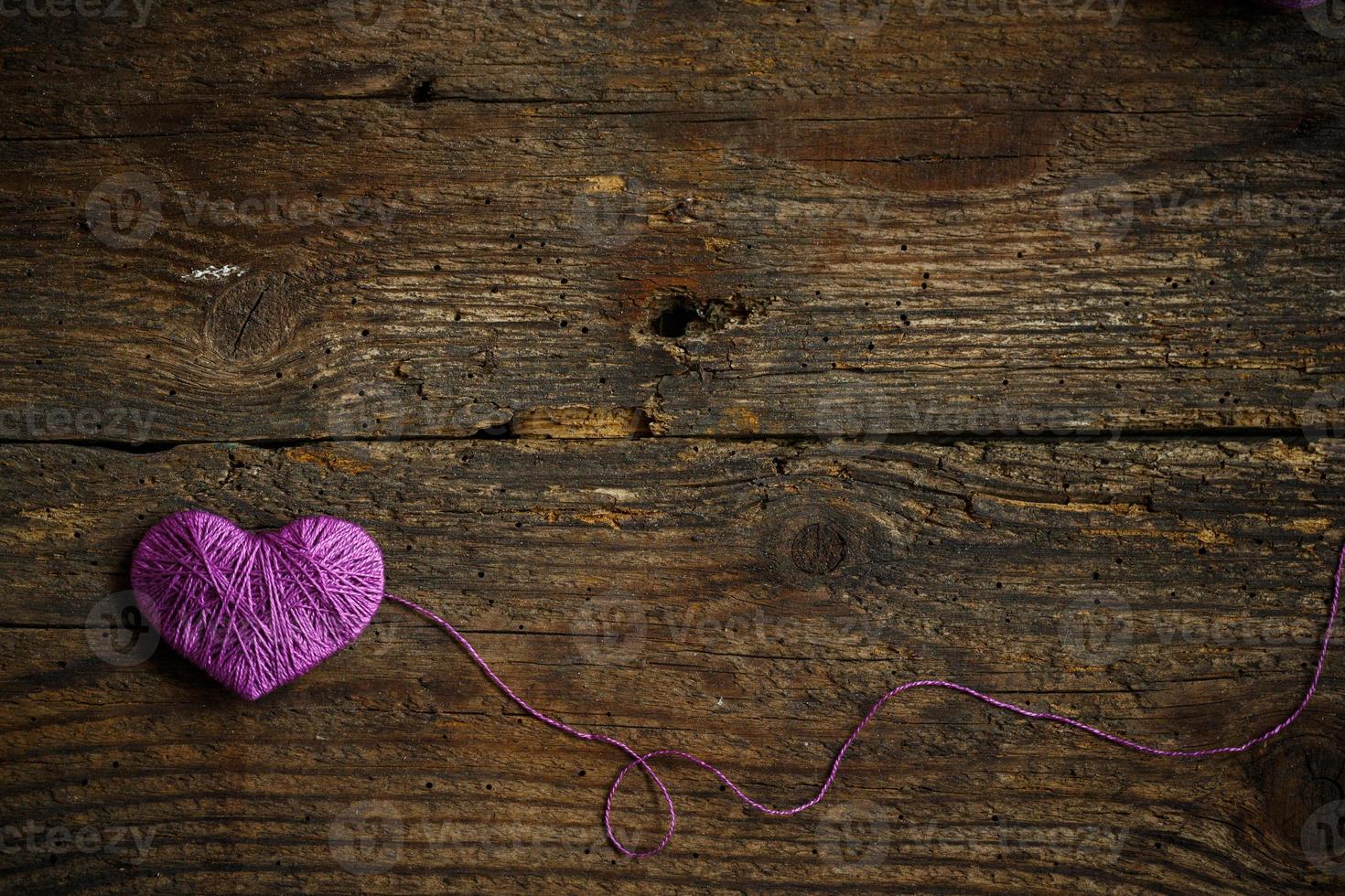 Purple Heart on on old shabby wooden background photo
