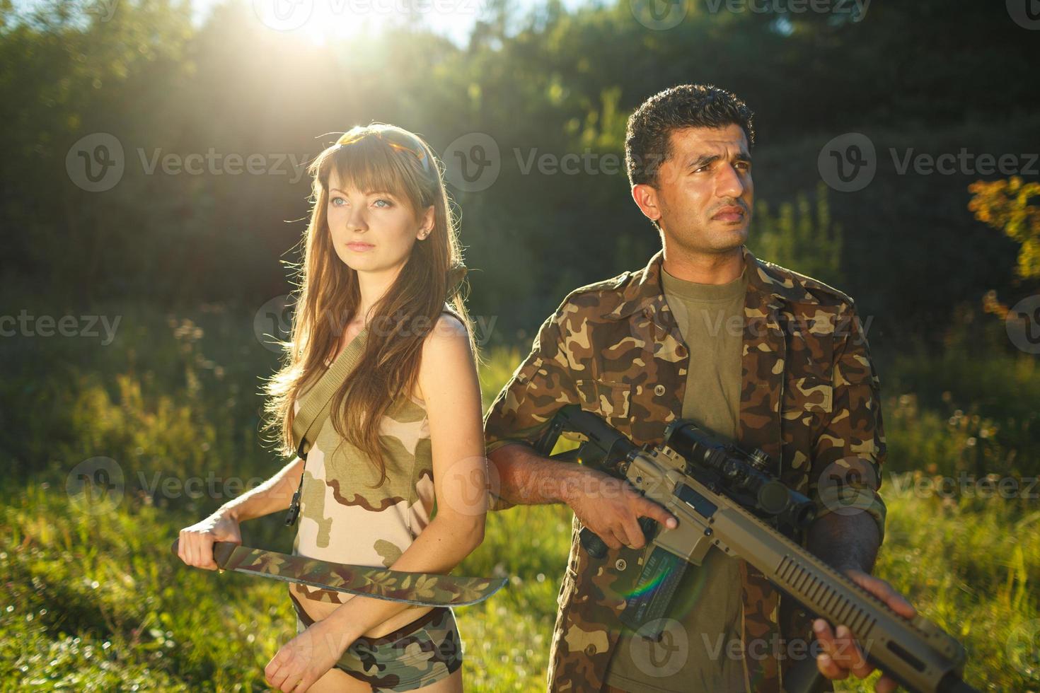 Young soldiers with machine guns photo