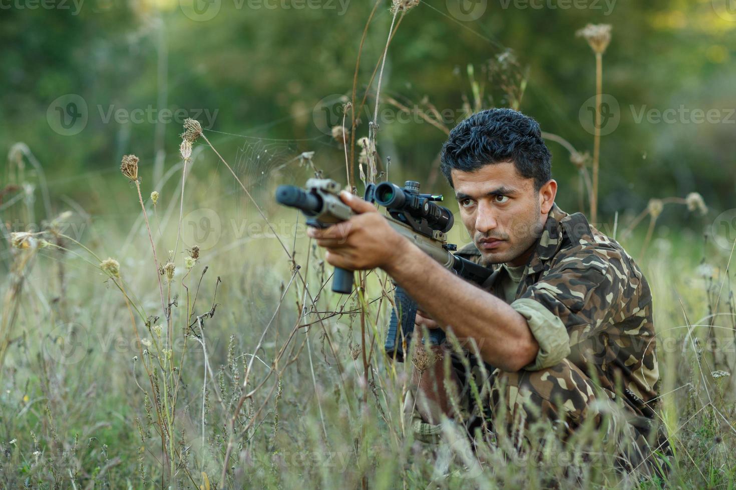 Young male soldier with machine gun photo