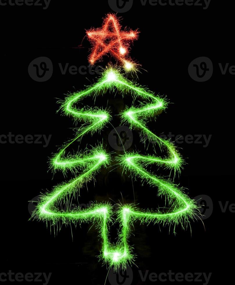 Christmas tree made by sparkler on a black photo