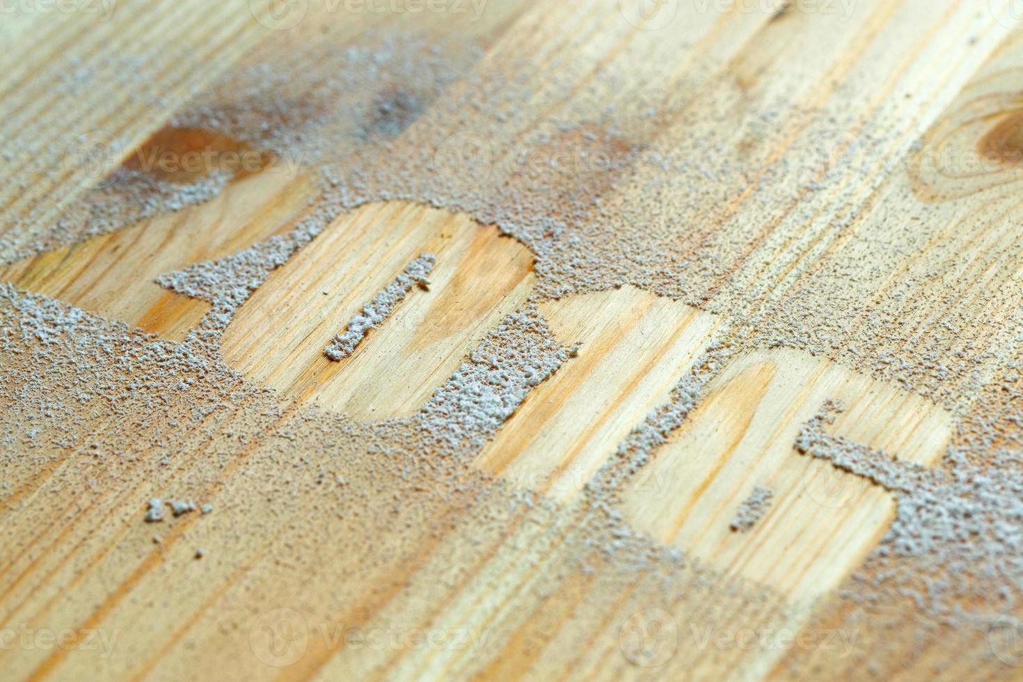 The inscription 2016 made with snow on the wooden background photo