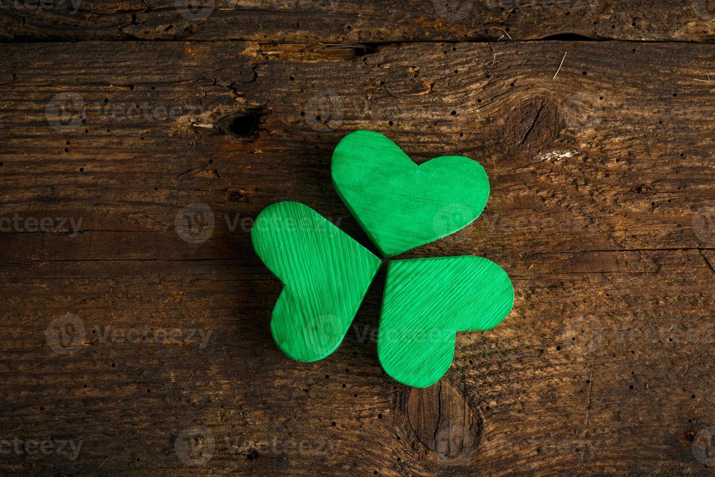 Green shamrock clovers on wooden background photo