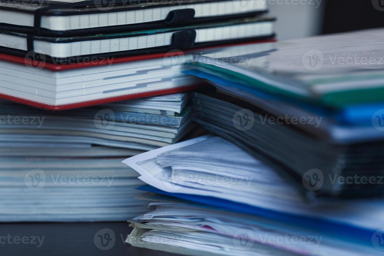 Accounting and taxes. Pile of magazine, notebook and books closeup photo