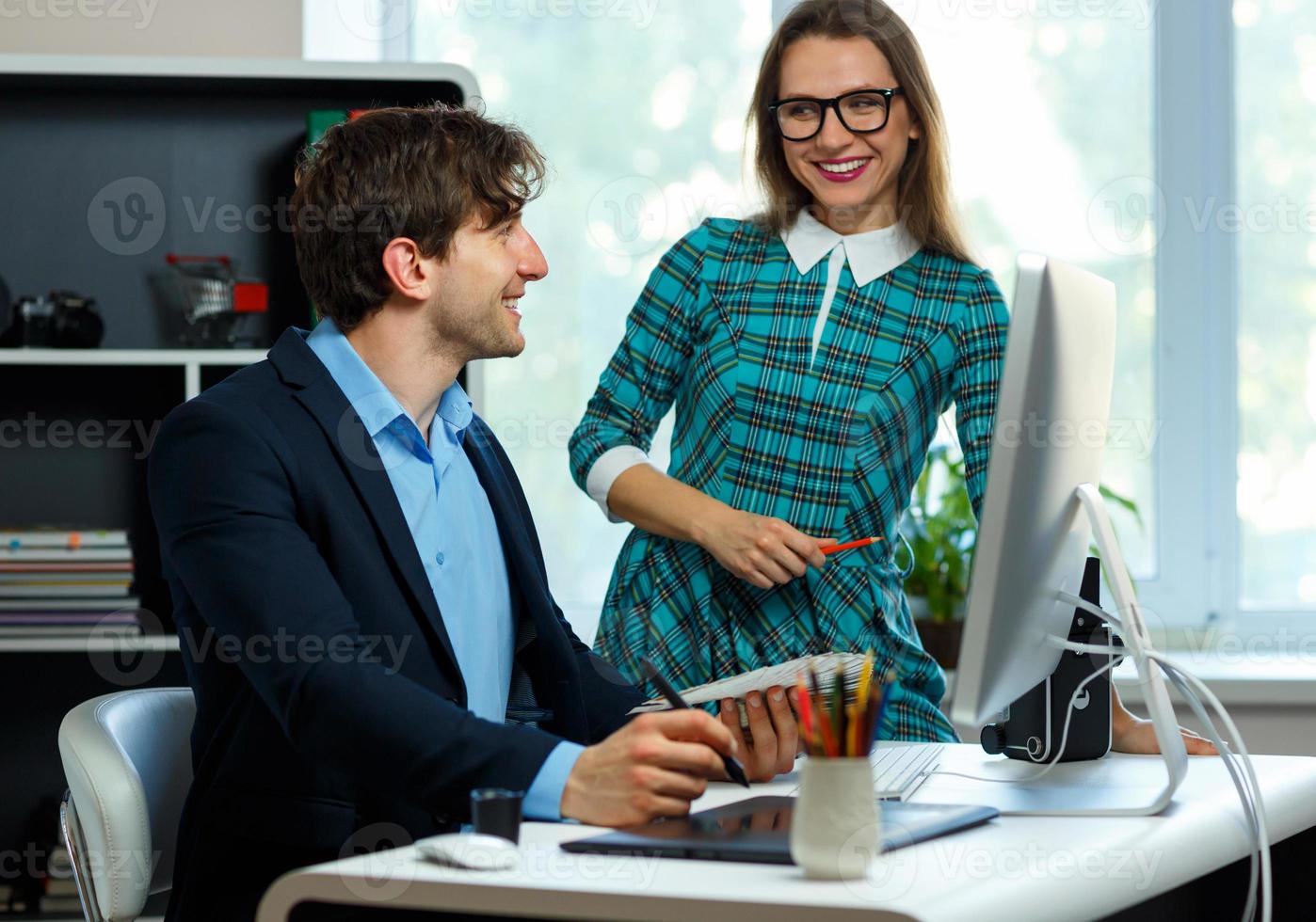 Beautiful young woman and man working from home photo