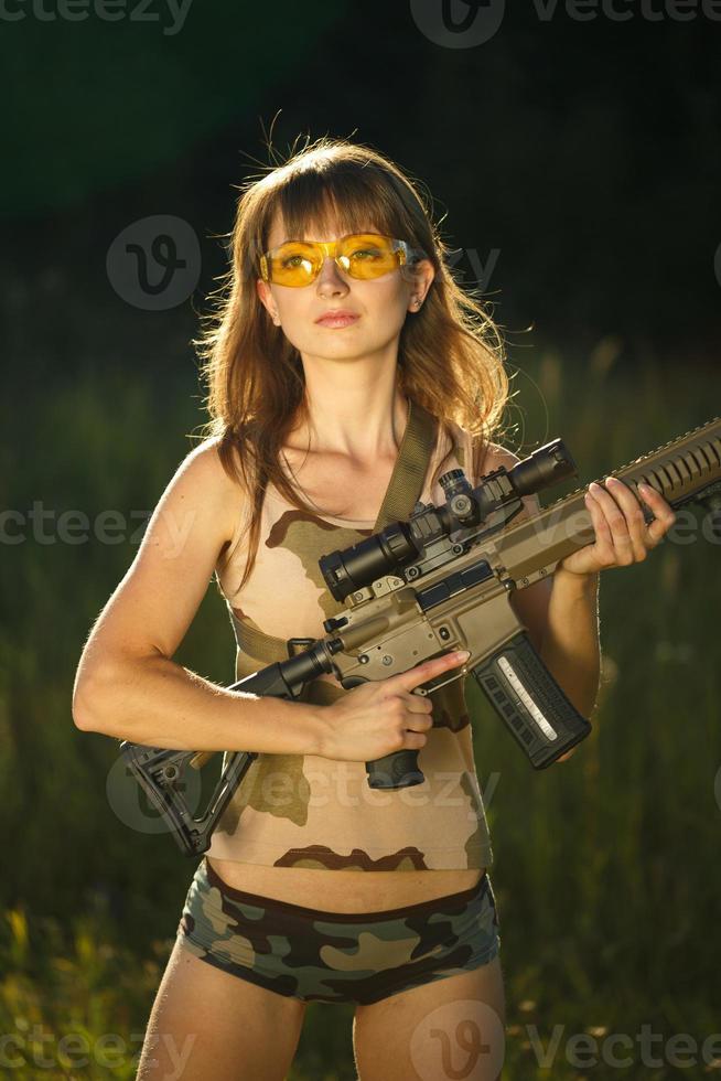 Young female soldier with machine gun photo