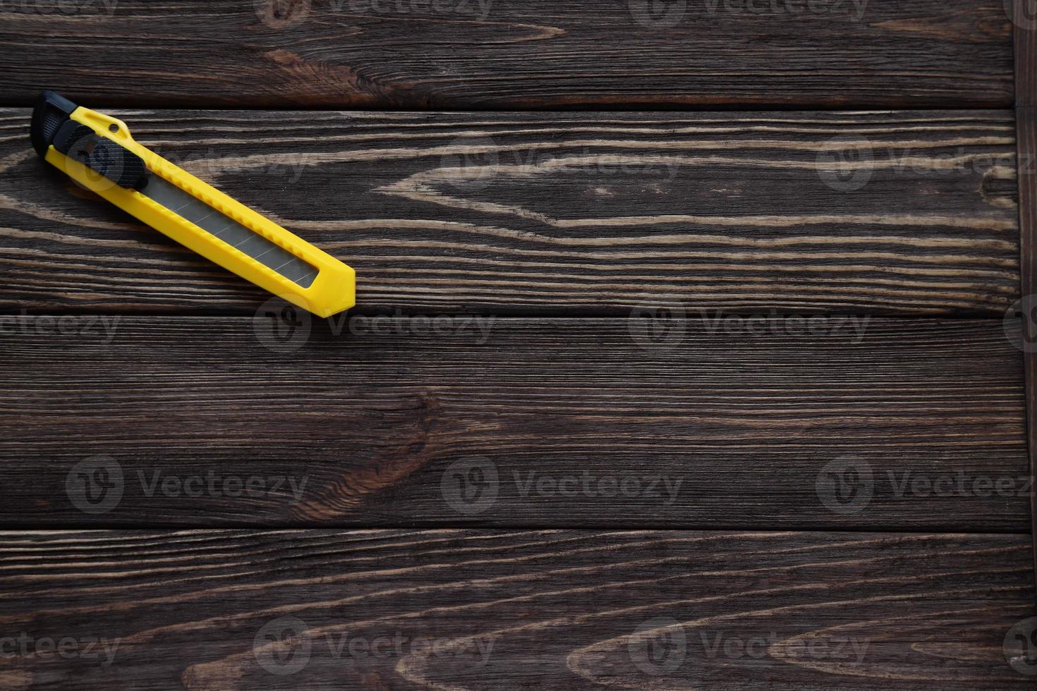 Bulding tool, knife professional on wooden table photo