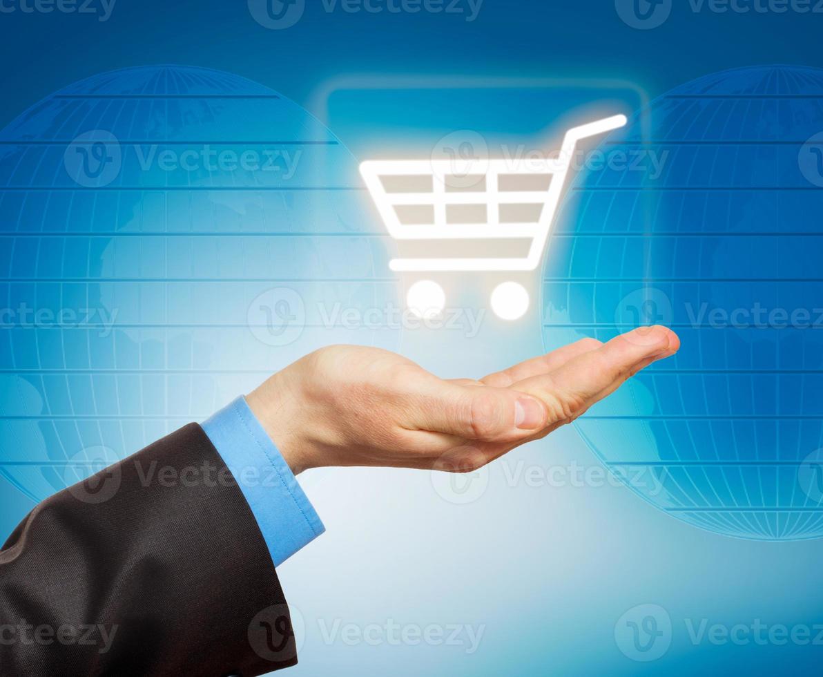 Man hand holding shopping cart icon photo