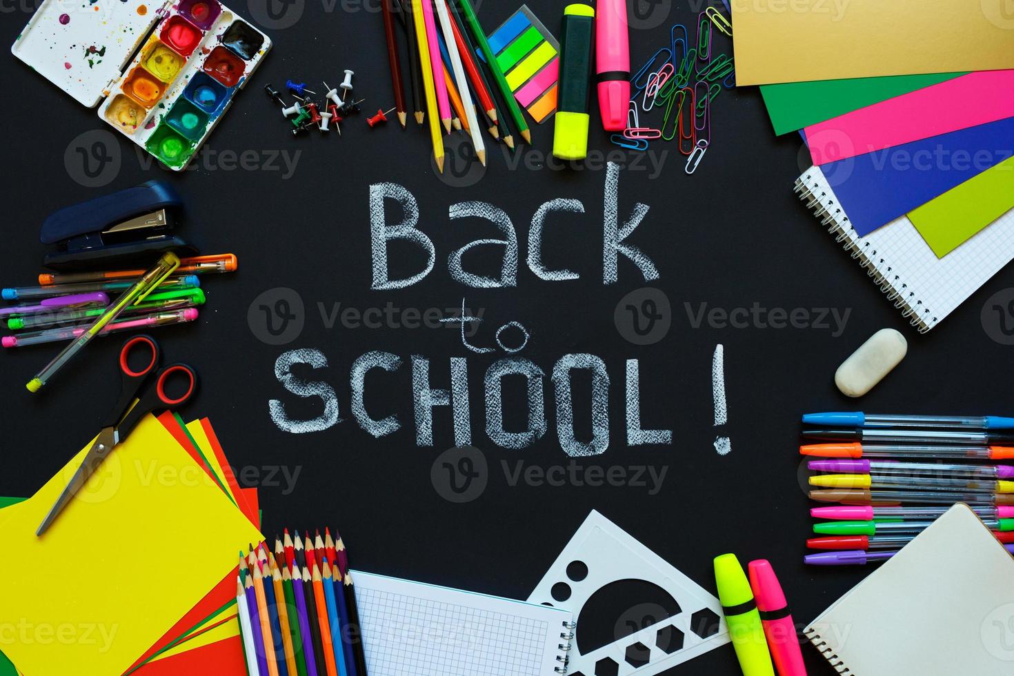 School supplies on blackboard background photo