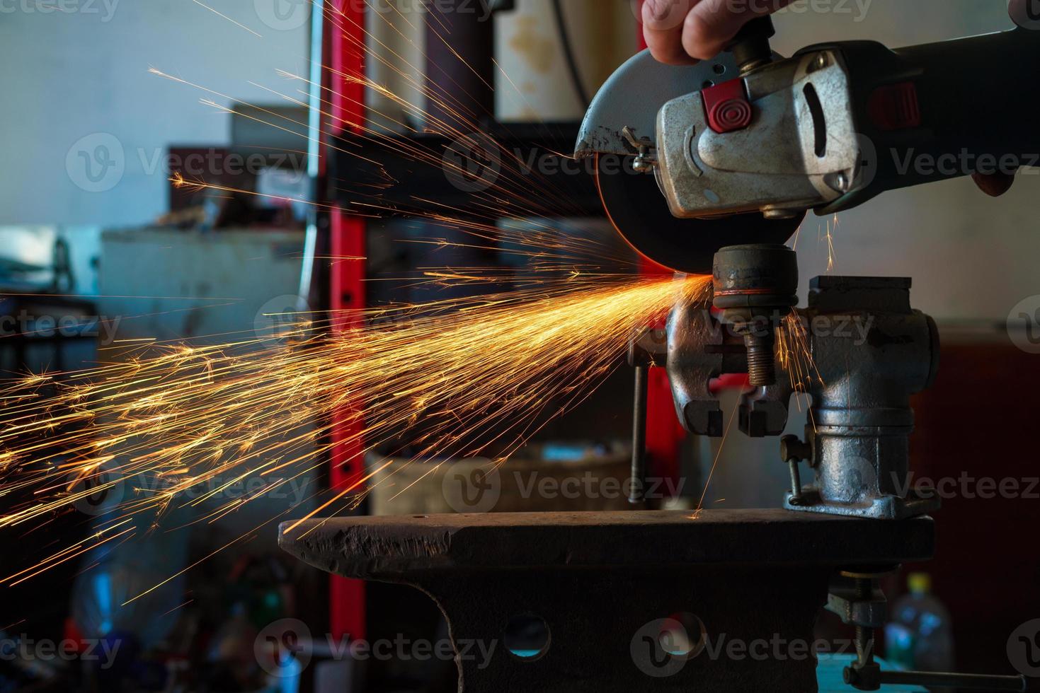 Angular grinding machine is cutting the metal photo