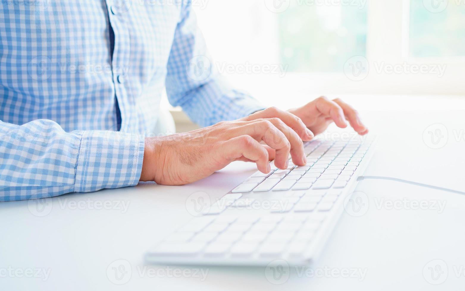 Men office worker typing on the keyboard photo
