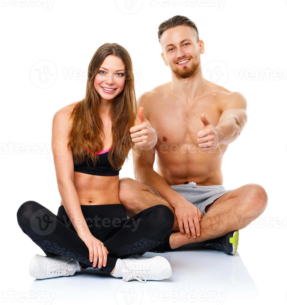 Sport man and woman after fitness exercise with a thumb up on the white photo