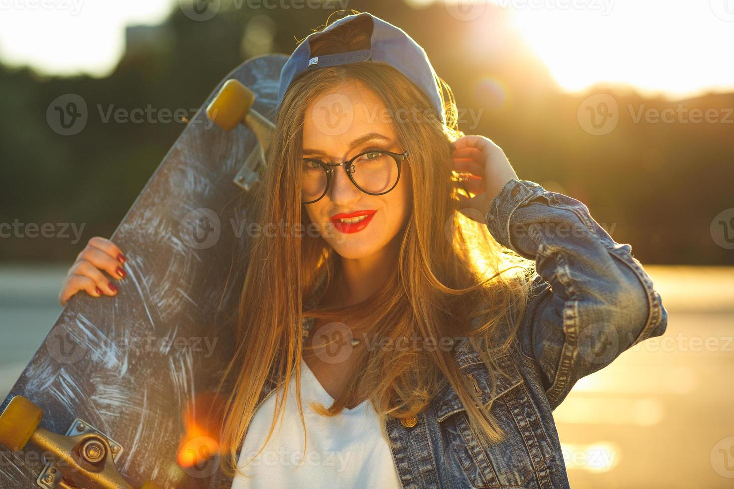 Young modern woman with skateboard photo