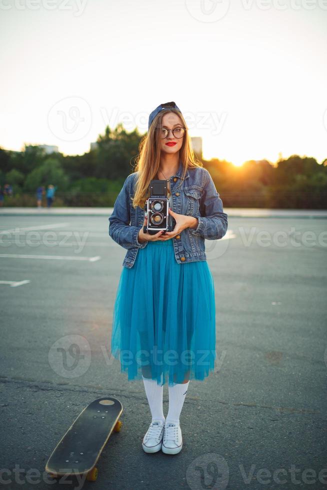 Young modern woman with skateboard photo