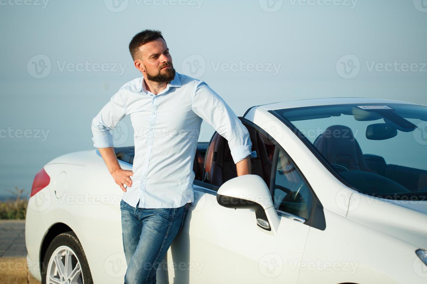 Young man with new car photo