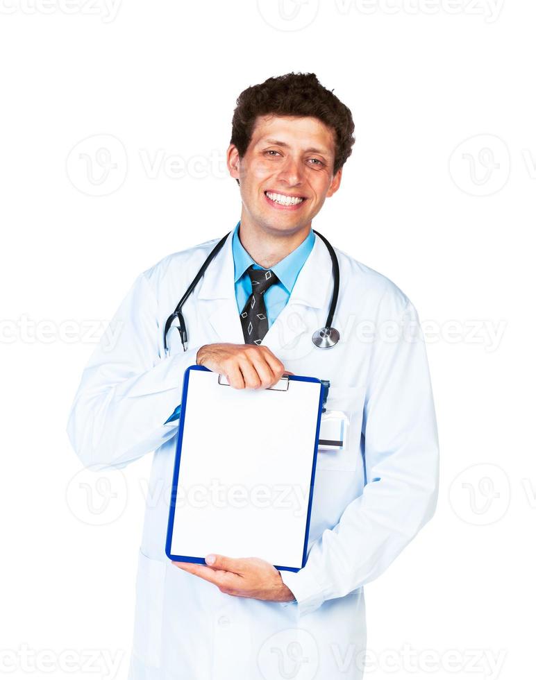 Young male smiling doctor showing clipboard with copy space for text on white photo